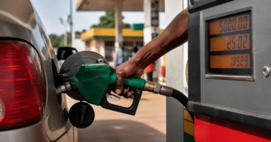 Petrol pump nozzle dispensing fuel into a car at a Nigerian filling station with price meter visible. Petrol prices in Nigeria explained