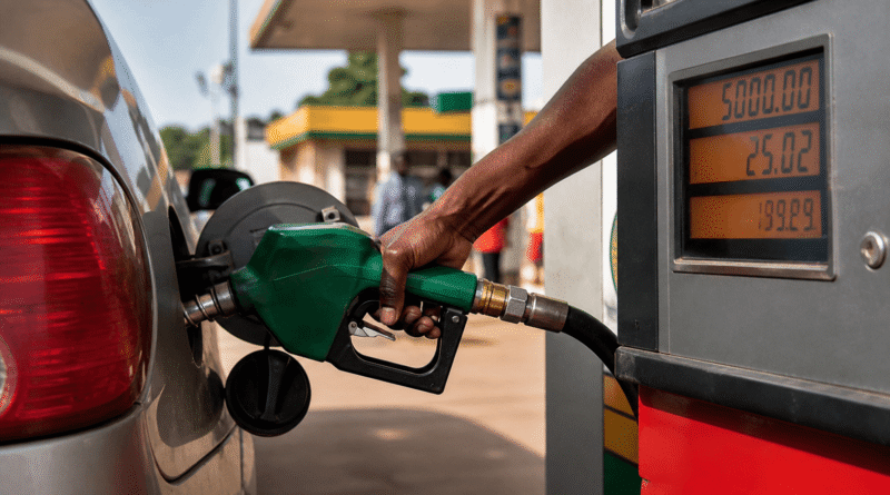 Petrol pump nozzle dispensing fuel into a car at a Nigerian filling station with price meter visible. Petrol prices in Nigeria explained