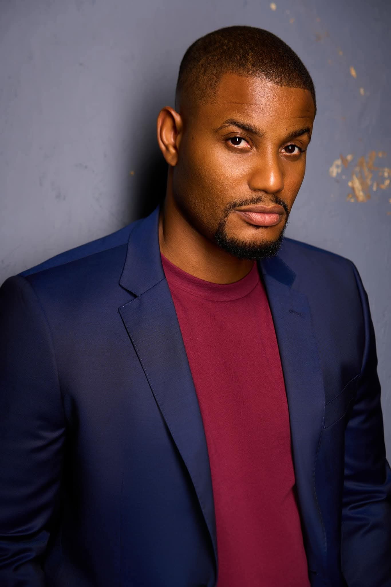 Portrait of late Nollywood actor Alexx Ekubo in a blue suit