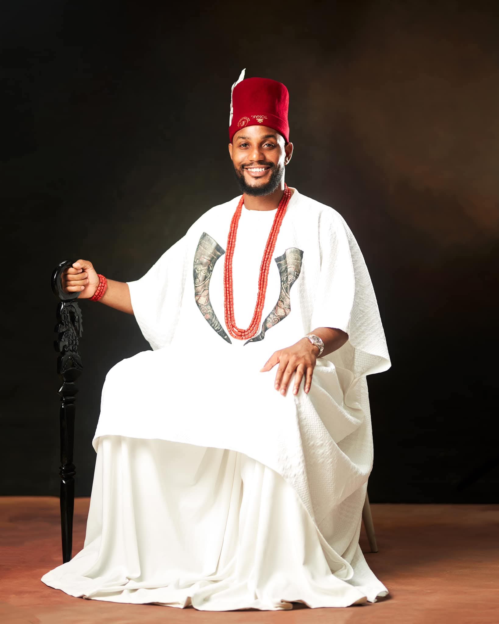Alexx Ekubo in white traditional attire during a portrait session